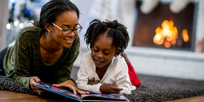 African American mother reading to child