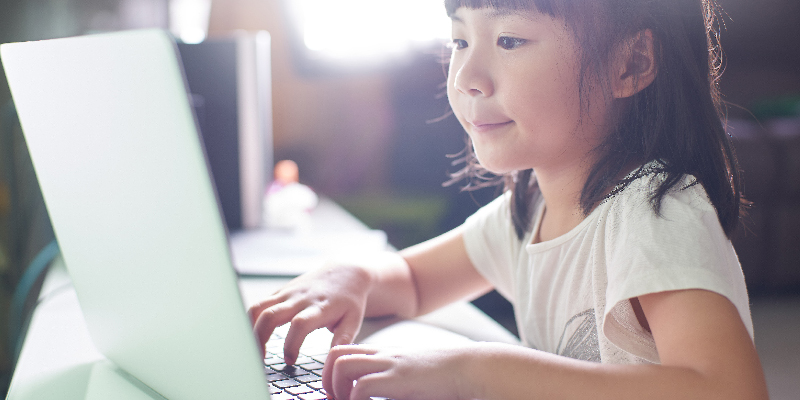 Little girl playing on computer