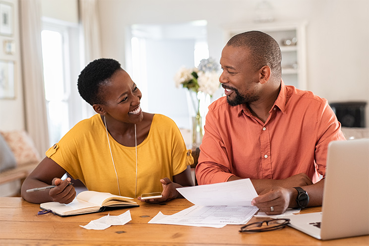 Parents at their home, reviewing bills