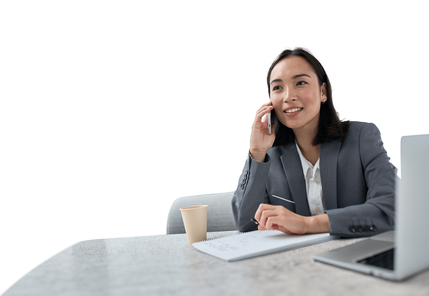 Sales professional at a table, with a cellphone and notebook