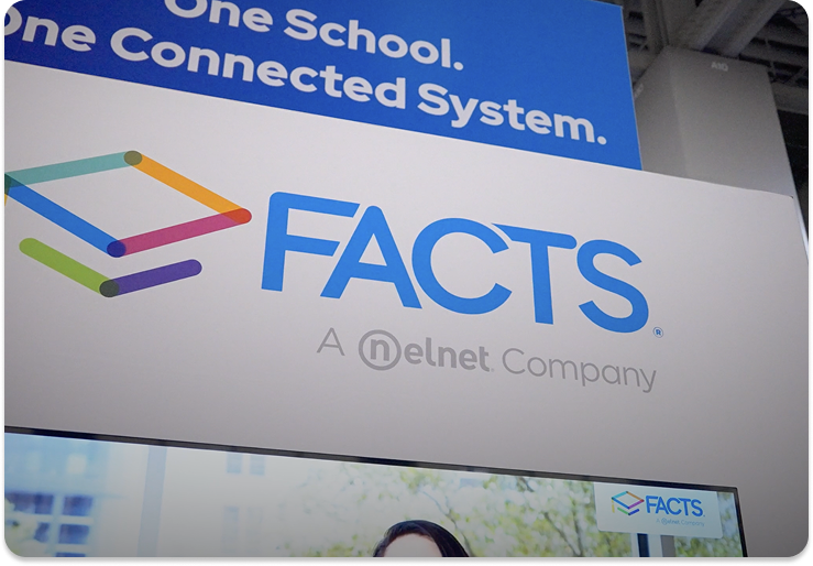 Close-up of a FACTS trade show booth sign featuring the FACTS logo and the tagline ‘One School. One Connected System