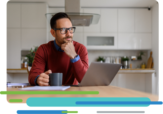 Person in kitchen with a mug and laptop computer