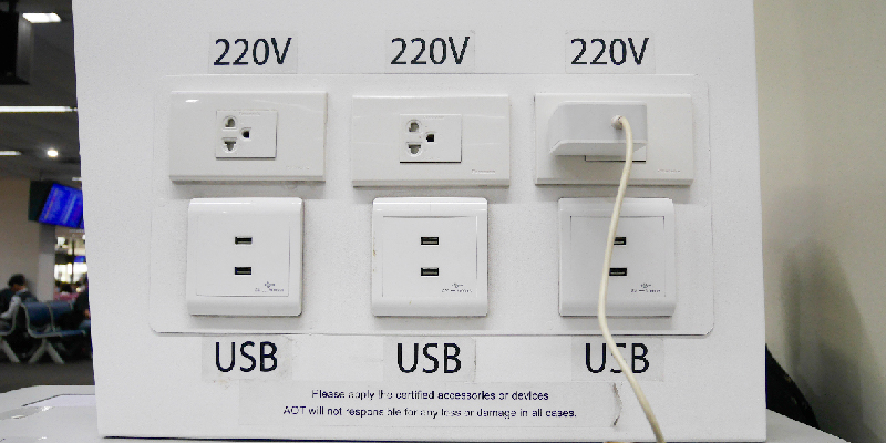 Person uses 220V charging outlets instead of USB ports to prevent data theft while charging their mobile phone.