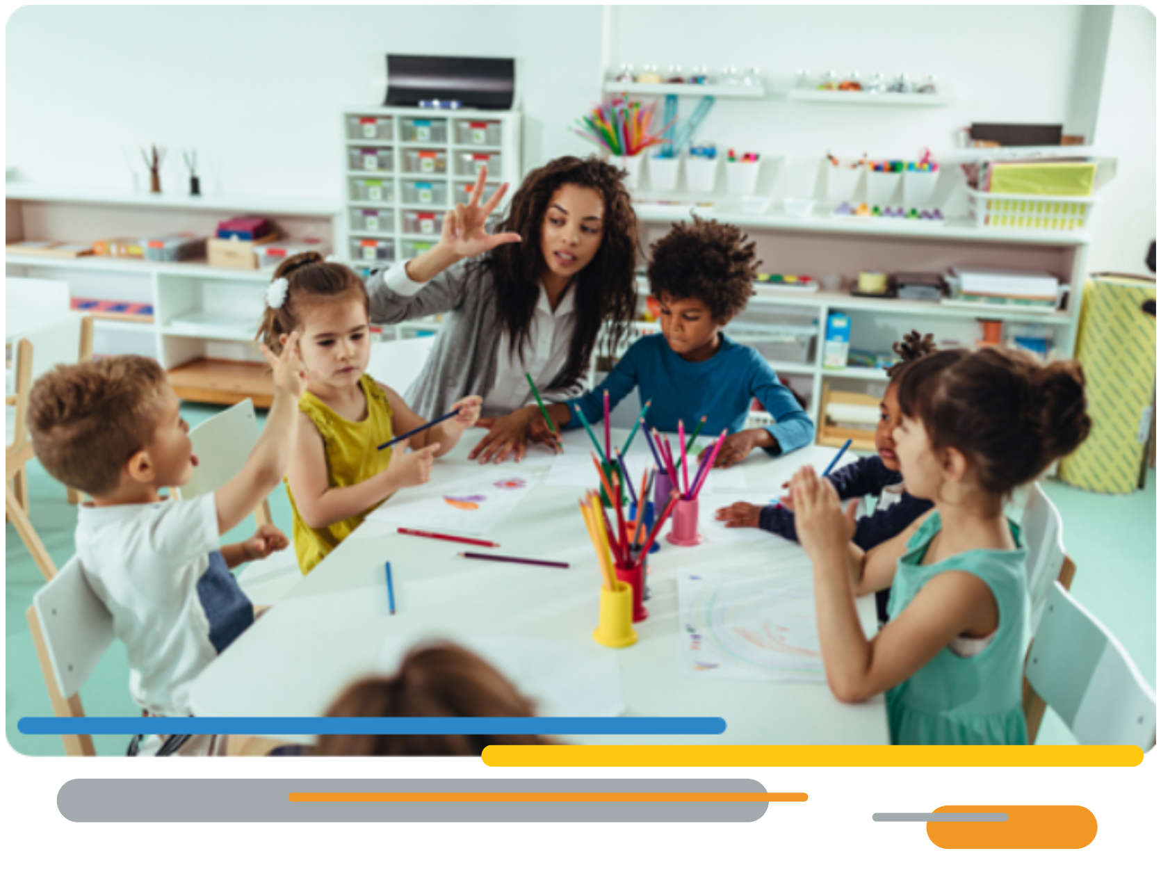 A teacher assisting children at their desk