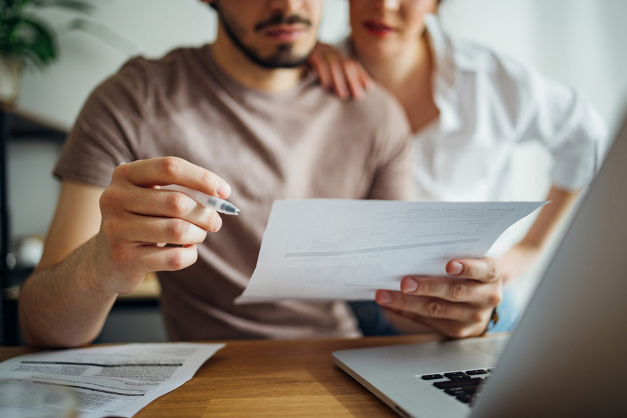 Two parents reviewing financial expenses